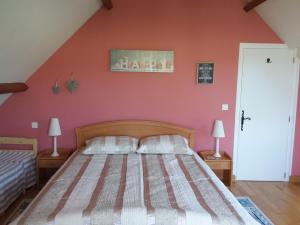 La Roche-lʼAbeilleMaison Maton的一间卧室设有一张床和红色的墙壁