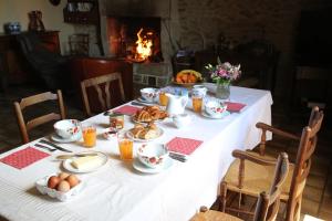 Saint-Denis-sur-SarthonChambre d'hôte Courtoux的壁炉旁的餐桌上摆放着食物和鸡蛋