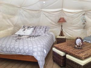加瓦尔尼Tipis nature的一间卧室配有一张床,帐篷内配有一张桌子