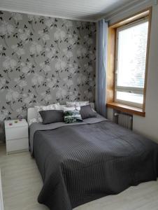 波里Anna Apartment的一间卧室配有一张带花卉壁纸的床