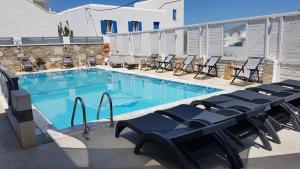 伊奥斯乔拉马科斯村庄酒店的一个带蓝色桌椅的大型游泳池