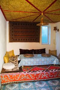 乔尔蓬阿塔Osobyi Guest house的一间卧室设有两张床和窗户。