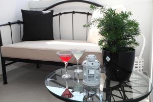 斯普利特Apartman Tara的一张玻璃桌,上面有两杯玻璃杯,沙发上