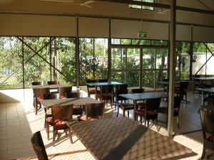 Batchelor丽池菲尔德酒店的一间空餐厅,配有桌椅和窗户