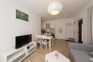 RudanovacPlitvice Retreat Apartments的带沙发、电视和桌子的客厅