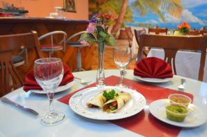 巴拿马城卡里贝巴拿马酒店的一张桌子,上面放着一盘食物和两杯酒杯