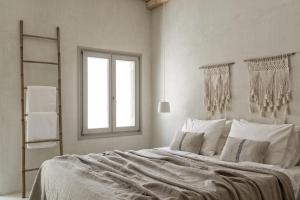 纳乌萨Giacomo Home by Rocks Estates的白色的卧室设有一张大床和一个窗户