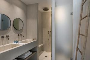 纳乌萨Giacomo Home by Rocks Estates的一间带水槽、镜子和淋浴的浴室