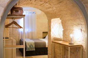 Hermanas Relais - trulli luxury客房内的一张或多张床位