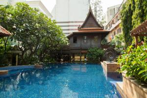 曼谷The Rose Residence, Bangkok的大楼前的游泳池