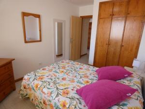 洛斯克里斯蒂亚诺斯Playa Lux Los Cristianos的一间卧室配有一张带紫色枕头的床
