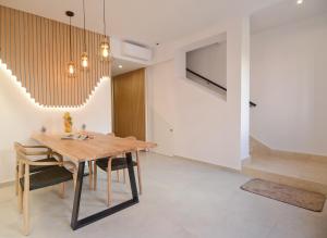 休达德亚Sagitario Petit Ciutadella的一间带木桌和椅子的用餐室