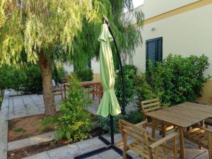 卡萨拉诺Sabell的一张桌子和长凳旁的绿色遮阳伞
