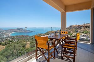普拉基亚斯Sellia resort的阳台的用餐室配有桌椅
