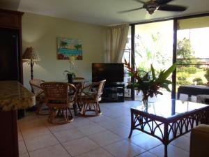 基黑Aloha KAI - Resort Condo的客厅配有桌椅和电视。