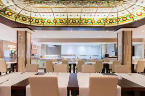 圣朱利安斯亚历山大酒店的一间带桌椅和天花板的用餐室
