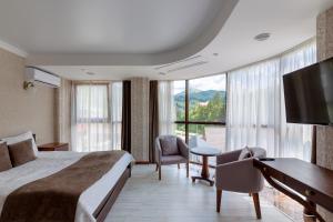 布克维卡帕洛萨酒店的酒店客房配有一张床、一张书桌和一台电视。