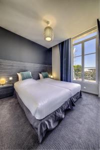 波尔多BDX Hôtel - Gare Saint-Jean的卧室设有一张大床,卧室设有大窗户