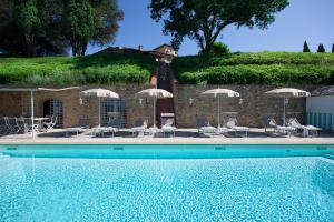 佩萨河谷塔瓦内莱Villa La Fornace的一个带躺椅和遮阳伞的游泳池
