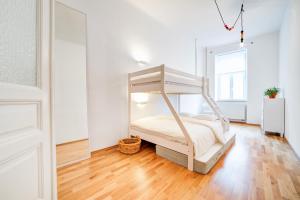 布尔诺Vachova Apartments的一间卧室配有一张床,铺有木地板