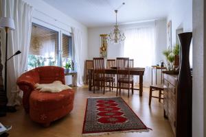 NiddaTektona "Bed & Breakfast"的客厅配有红色椅子和桌子
