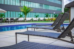 卡马萨里卡木布斯酒店的游泳池旁几把椅子