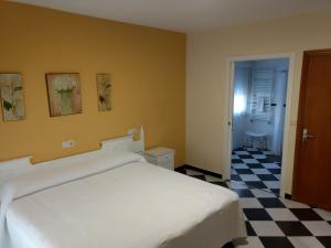 桑亨霍马林安旅馆的卧室配有白色的床和 ⁇ 格地板