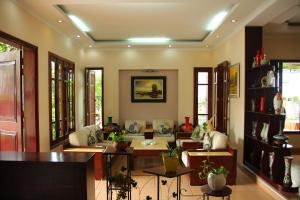 下龙湾Hạ Long Lily Homestay的客厅配有沙发、桌子和窗户