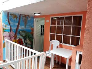 圣安德烈斯Posada J&J Forbes - 2的阳台配有桌椅和壁画