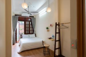 河内Nusmile's Homestay & Travel的一间卧室设有一张床、梯子和窗户