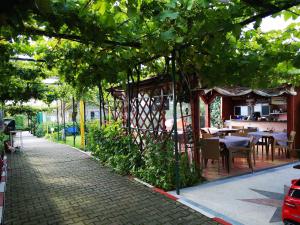 道泽兹西特里奥格裴森尼娜酒店的一条鹅卵石街道上,设有餐厅,配有桌椅