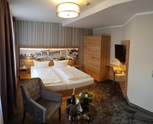 施滕达尔施瓦泽阿德勒施滕达尔酒店（原阿特马克酒店）的配有一张床和一把椅子的酒店客房