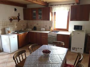 PécselyKikapcsol-lak的厨房配有桌子、冰箱和水槽