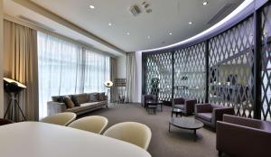 热那亚贝斯特韦斯特酒店CHC机场店的客厅配有沙发、椅子和桌子
