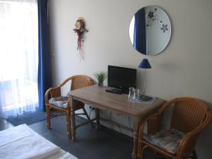 特里贝格伽尼中心酒店的客房设有一张桌子、一台电脑和两把椅子