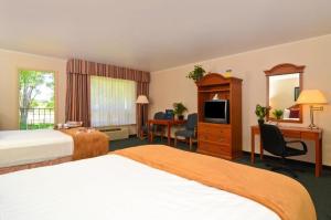 蒙特罗斯Red Arrow Boutique Hotel的酒店客房设有两张床和电视。