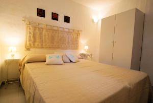 瓦雷多利亚Sa Fiorida case vacanze的一间卧室配有一张大床和两个枕头