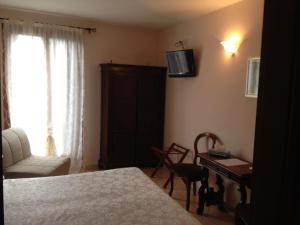 威尼斯洛坎达萨利埃瑞酒店的一间卧室配有一张床、一张书桌和一台电视