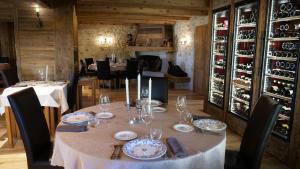 Les Verrières-de-JouxLe Tillau的餐厅里一张带盘子和酒杯的桌子