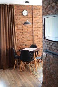 切尔尼戈夫Apartment near Megacenter的一间设有桌椅和砖墙的用餐室