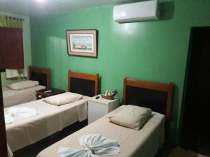 三玛丽亚镇Pousada Rural Veredas的绿墙客房内的两张床