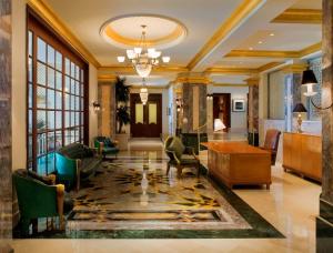 马斯喀特凯悦大酒店马斯喀特的客厅设有配有桌椅的大堂