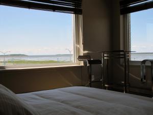 里穆斯基圣日耳曼里姆斯基酒店的一间卧室配有一张床,享有海景