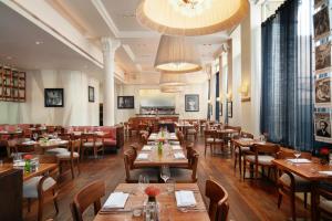 利物浦经典英国哈德戴斯夜间酒店的一间带木桌椅的餐厅和一间用餐室