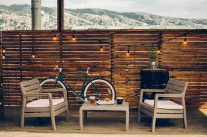 瓦尔帕莱索拉霍亚旅舍的一辆自行车停在两把椅子和一张桌子旁边