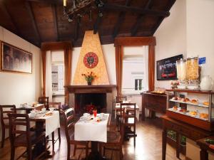罗马潘泰翁旅馆的一间带桌椅和壁炉的餐厅