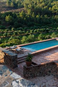 EscaladeiTerra Dominicata - Hotel & Winery - Adults Only的一座游泳池,旁边设有两张野餐桌