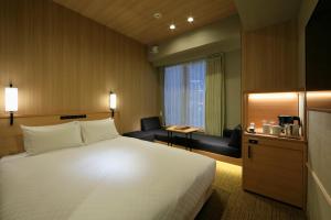 神户托尔路坎迪奥酒店客房内的一张或多张床位