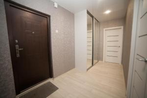 克拉斯诺亚尔斯克Alekseyeva Apartament的走廊上设有黑色的门和步入式衣柜