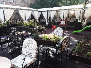 维丁海王星酒店的庭院配有桌椅和盆栽植物